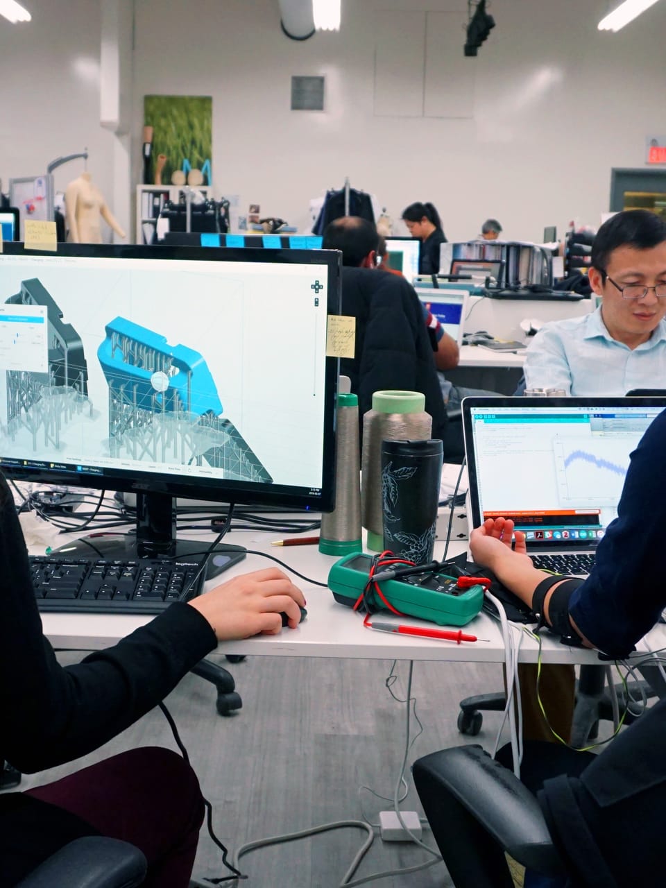 Two engineers reviewing a prototype together at the bench