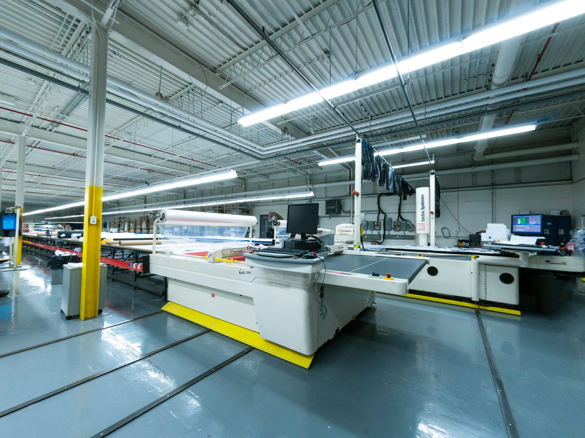 The main production hall, computer-controlled cutting table in the foreground