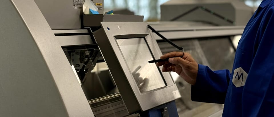 A MyantX engineer reviewing a build at the machine