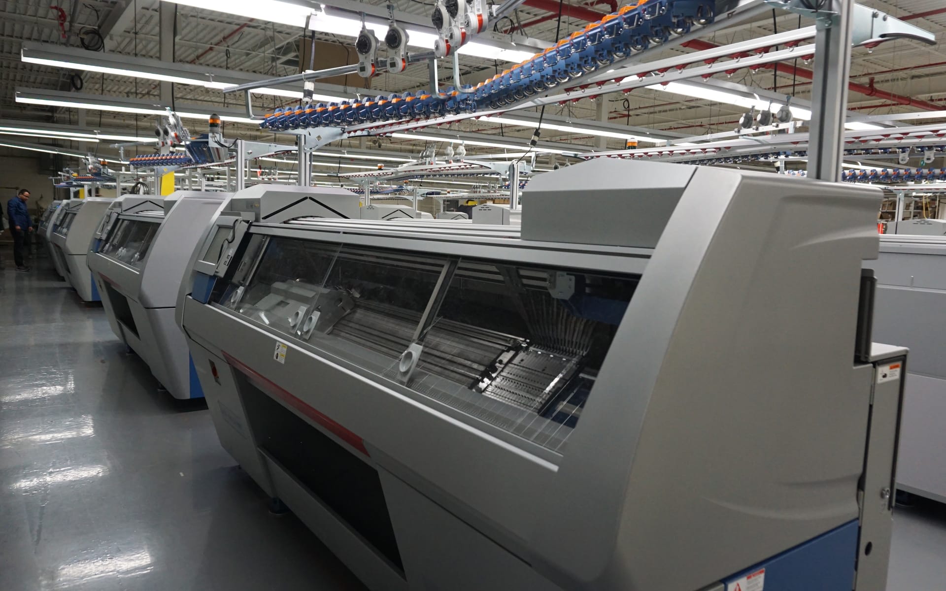 Robotic flat-knitting machines on the Myant DTX production floor