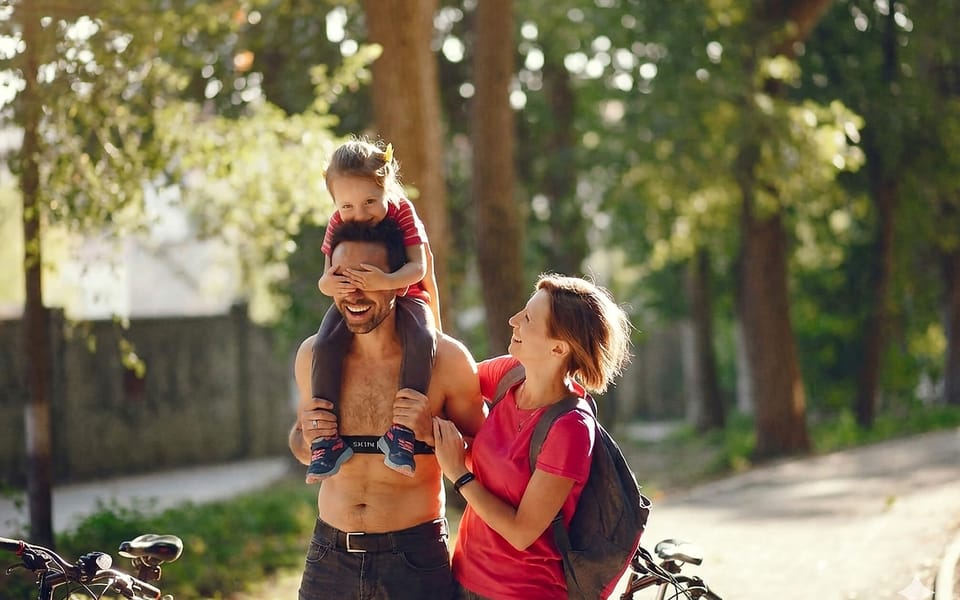 A family outdoors, one wearing a SKIIN ECG chest band under everyday clothes