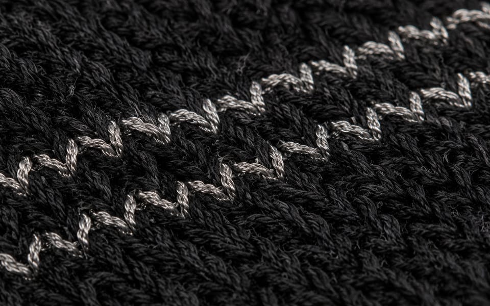 Macro of a conductive strand knitted through the fabric structure