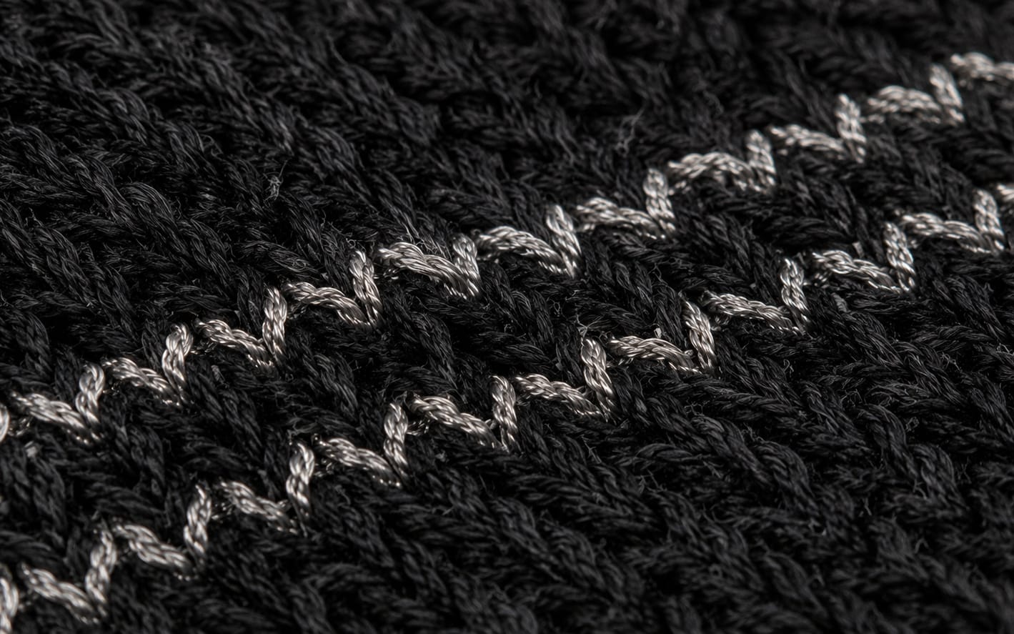 Robotic flat-bed knitting machines building sensing structure into the textile