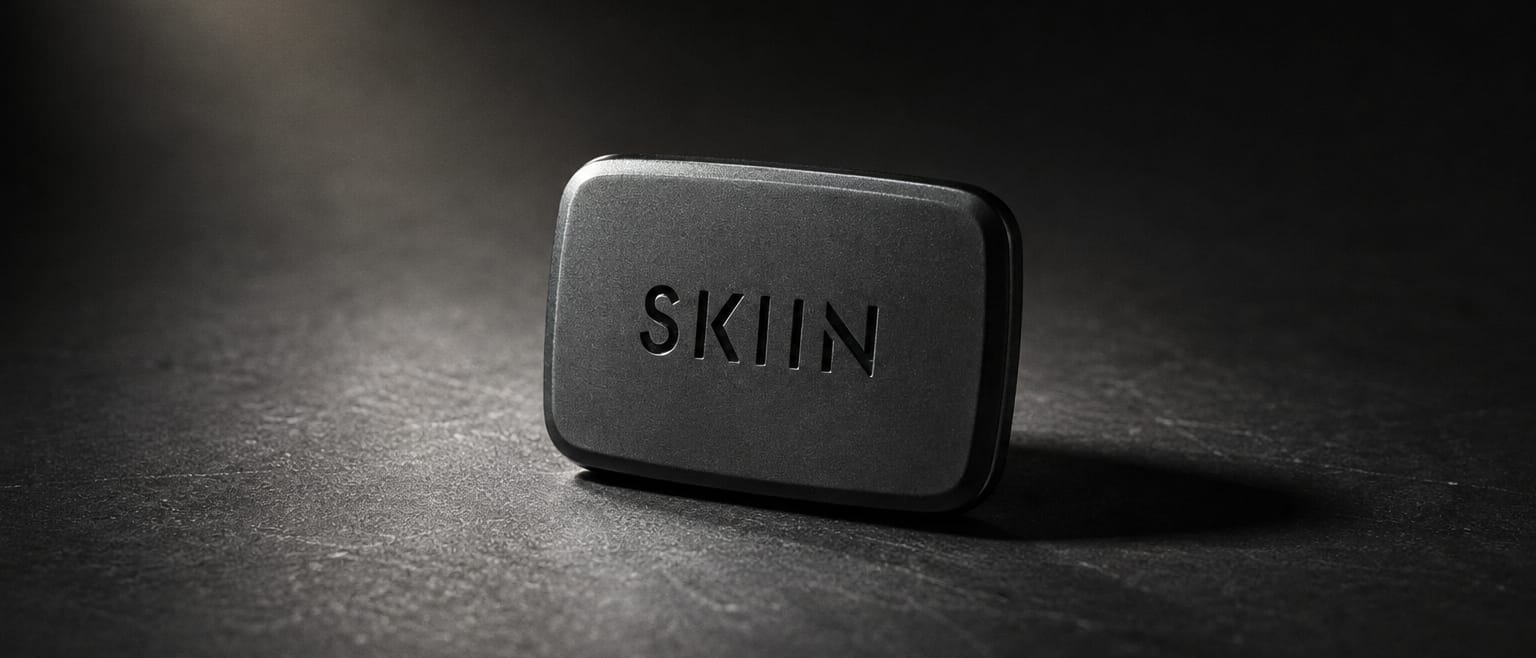 The SKIIN pod — the snap-on sensing module — on a dark ground