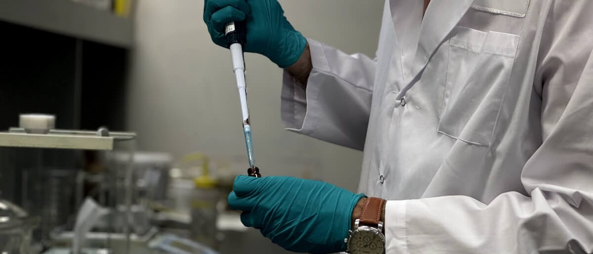 An analyst preparing a sample for measurement in the MyantX laboratory