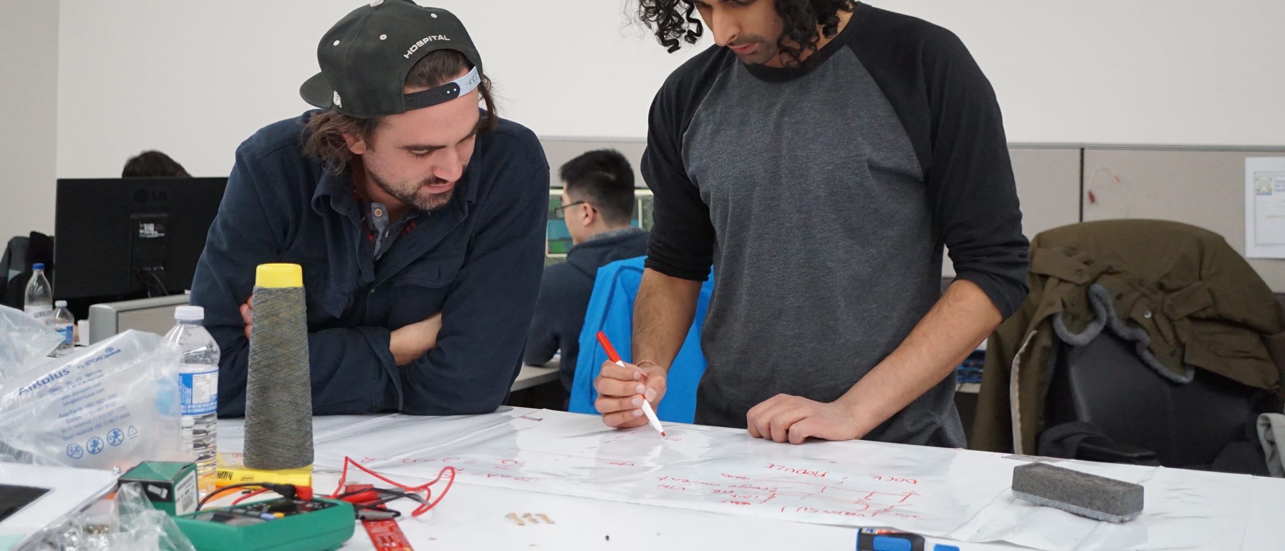 Engineers working through a connected product at the development bench