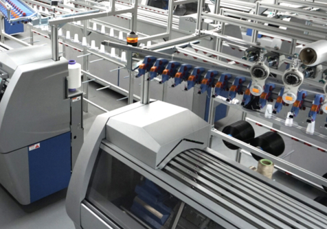 High-tech manufacturing setup at Myant X's world-class facility with automated machinery and conveyor systems.